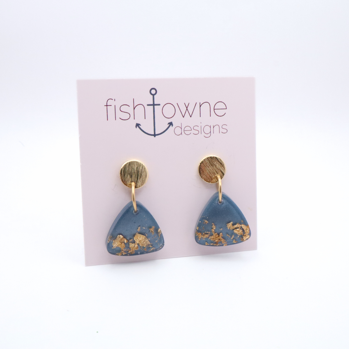 Blue triangle earrings with gold accents on a Fish Towne Designs card.