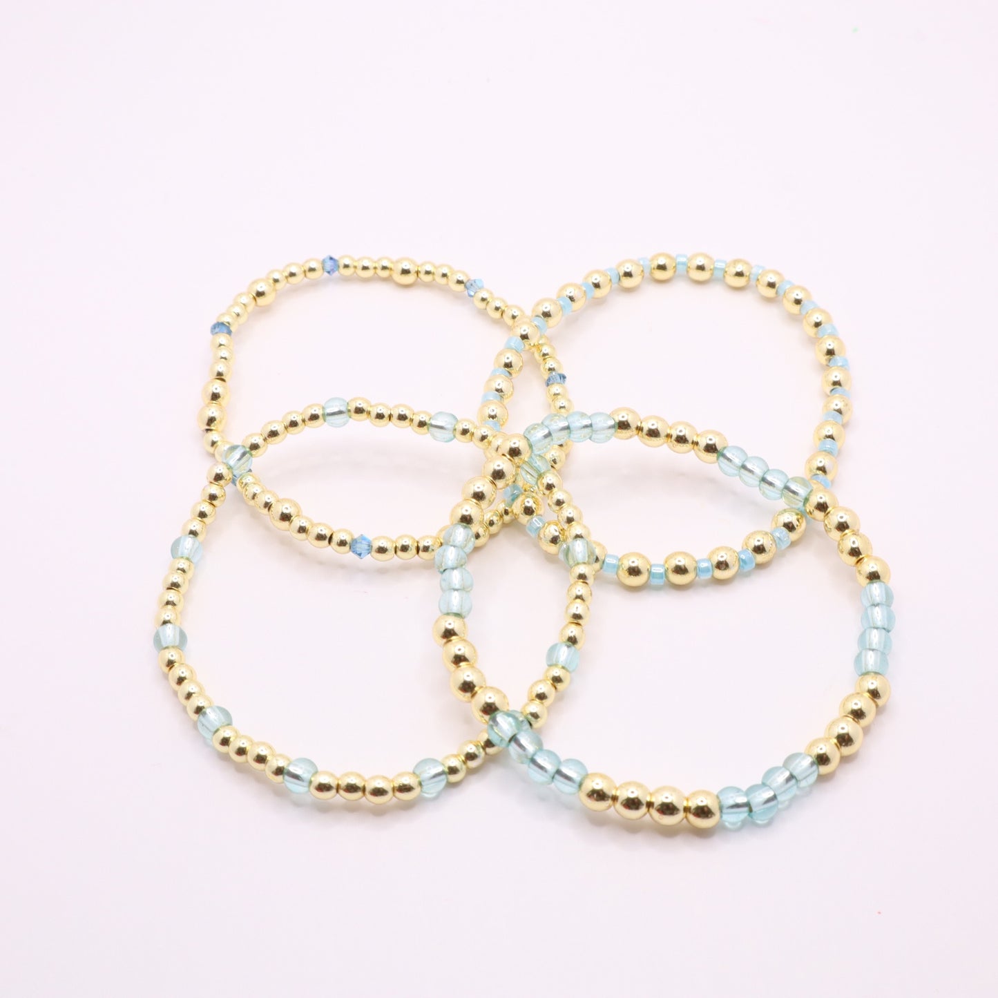Blue and gold bracelet stack styled together for an elegant layered jewelry look.