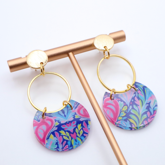 Lightweight acrylic dangle earrings with bold pink and blue floral print paired with gold hoop and 18k gold plated textured stud posts