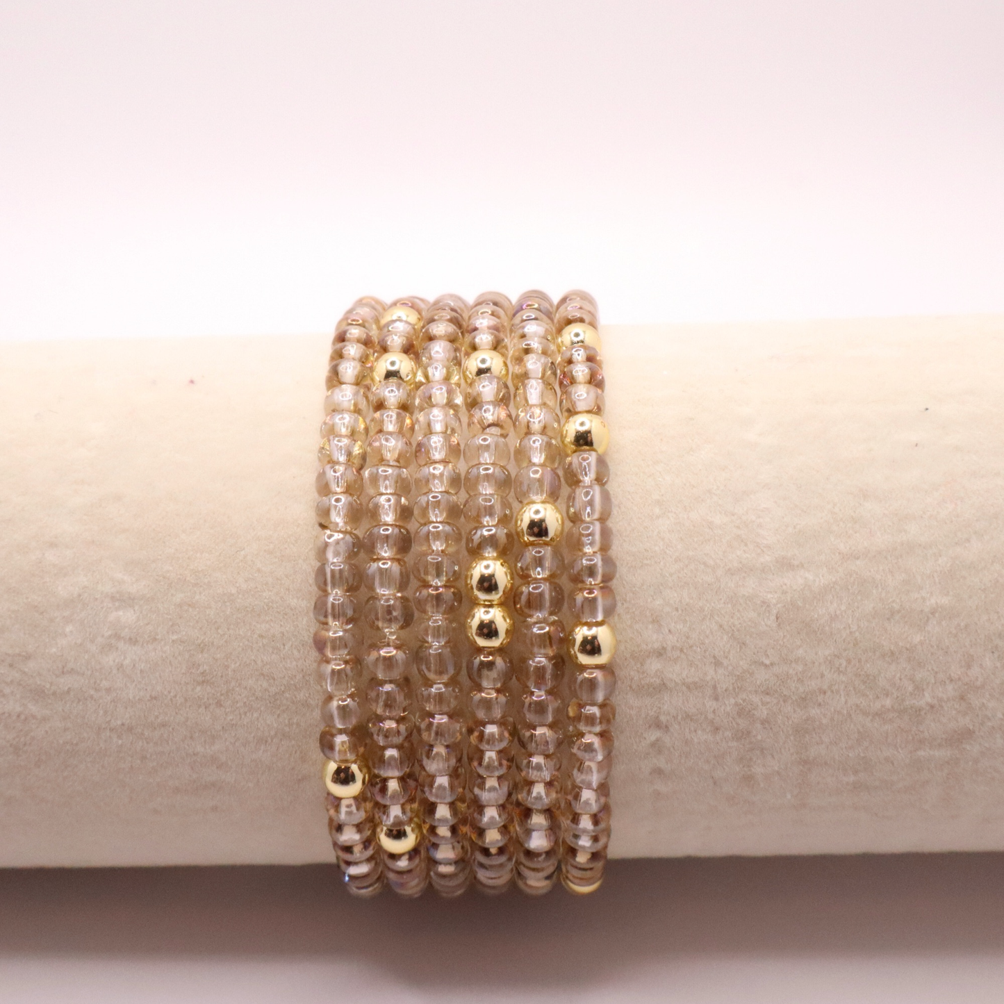 set of six neutral gold tone seed bead bracelets featuring high quality neutral seed beads and golden hematite accent beads. The stack is displayed on a white background.