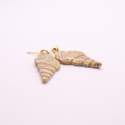 Elegant beach-inspired seashell dangle earrings with gold detailing and shimmer