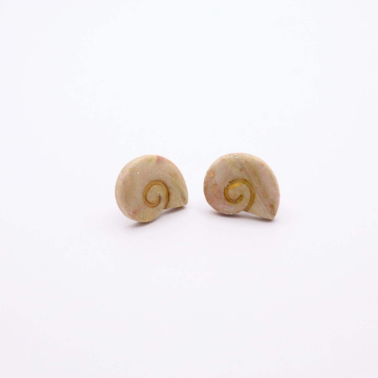 Minimalist ocean-inspired shell stud earrings in creamy blush tones with gold accents