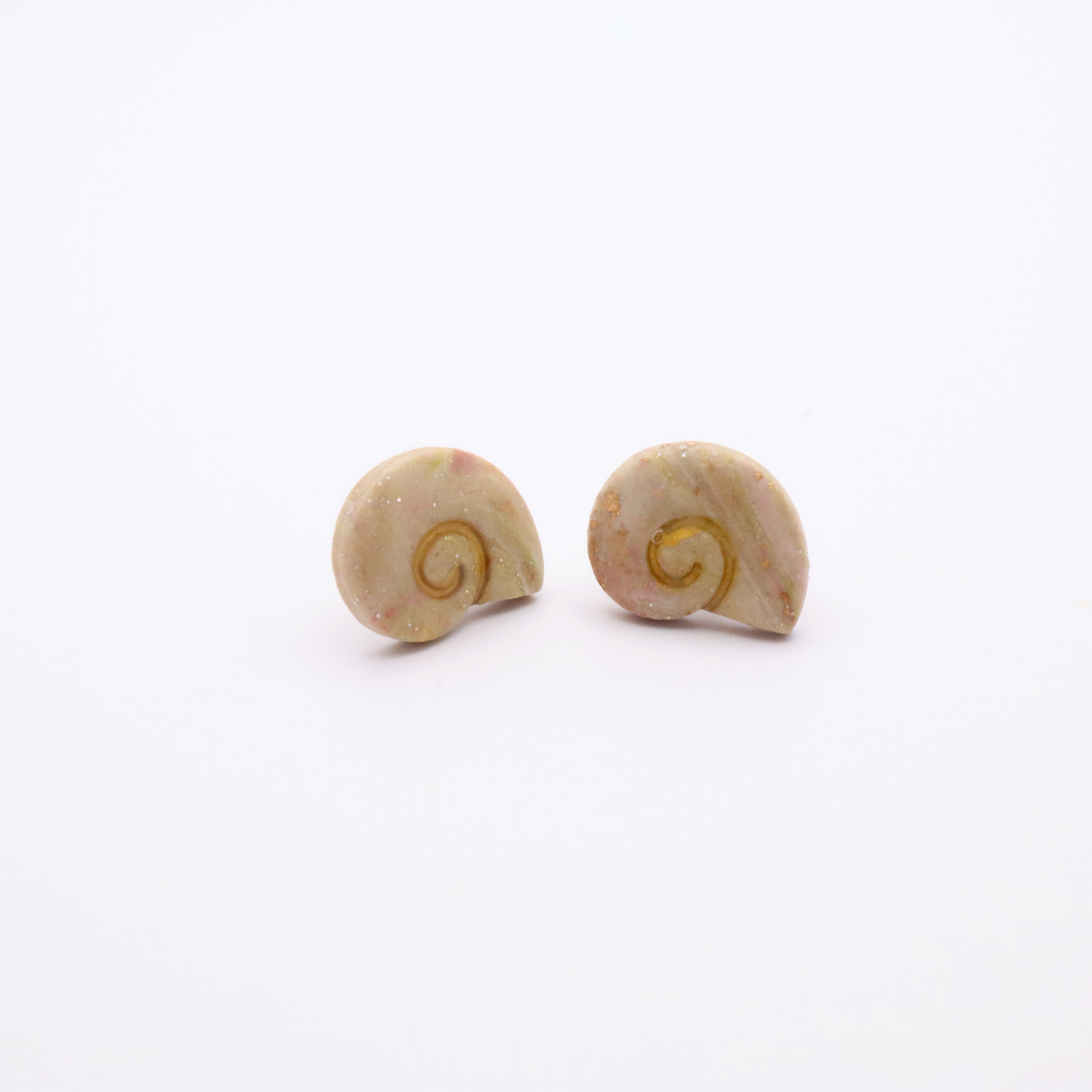 Minimalist ocean-inspired shell stud earrings in creamy blush tones with gold accents