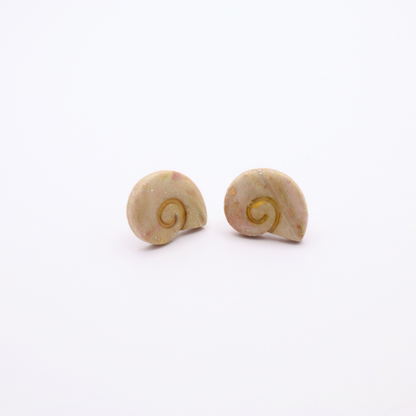 Minimalist ocean-inspired shell stud earrings in creamy blush tones with gold accents