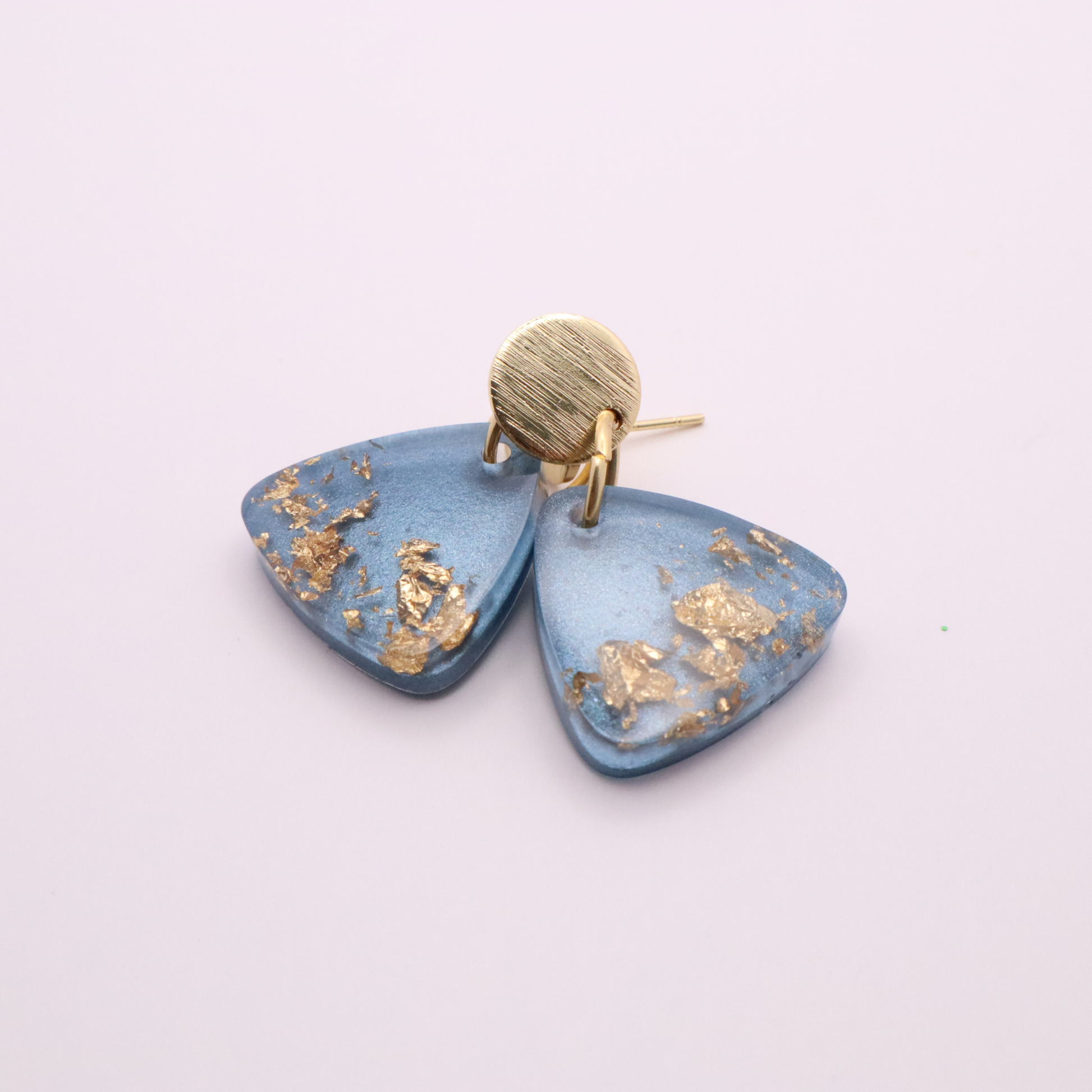 Blue earrings with gold accents on a white background
