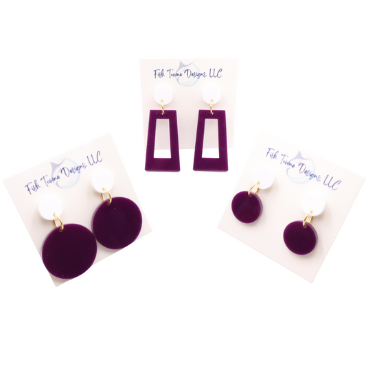Purple earrings on display cards with 'Fish Towne Designs LLC' branding.