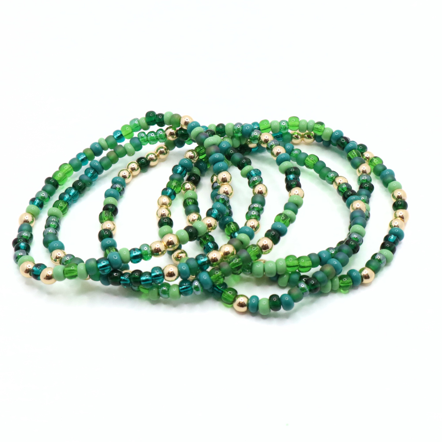 Set of six green beaded bracelets on a white background