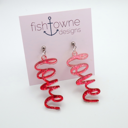 Pink glitter 'love' earrings on a Fish Towne Designs Display Card
