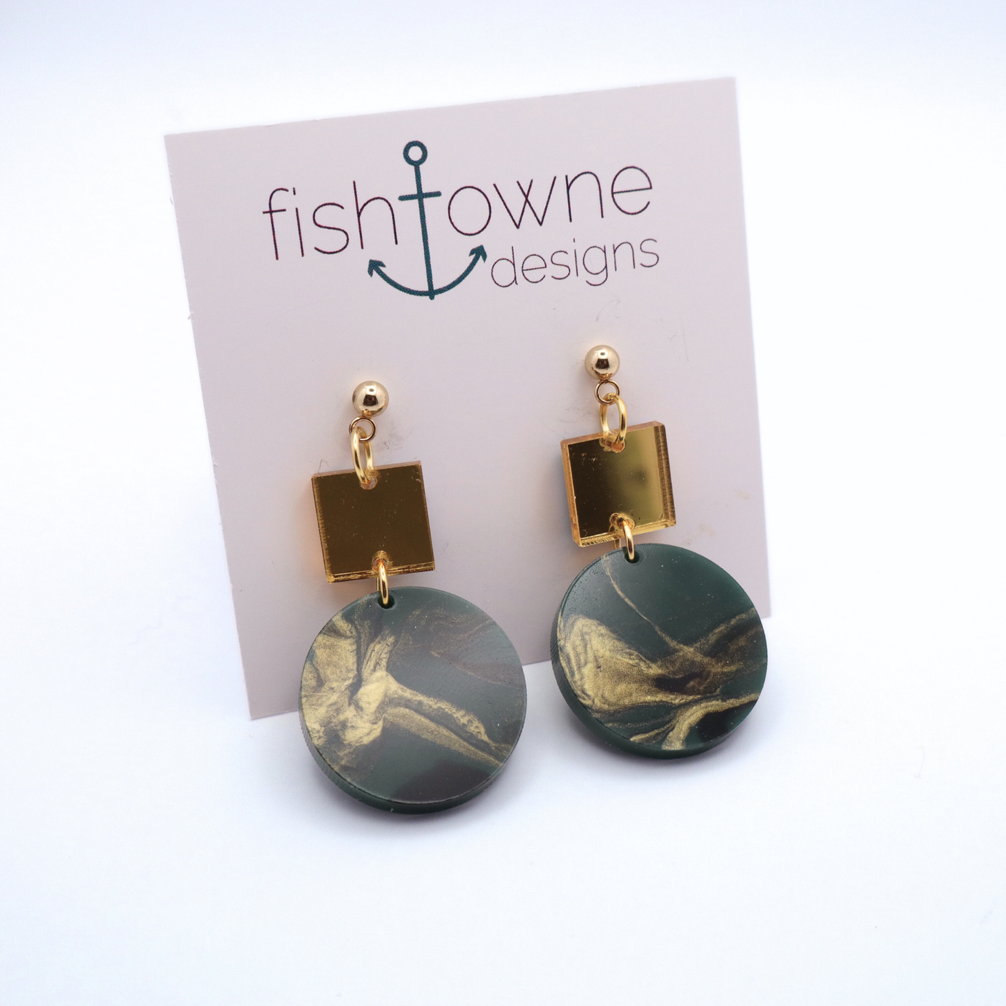 Pair of earrings with green and gold marbled design on a Fish Towne Designs card.
