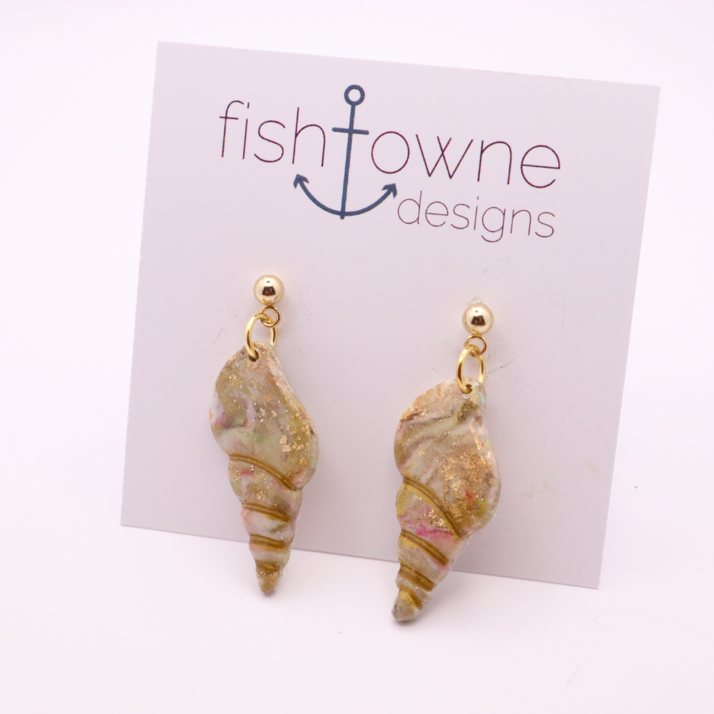 Handmade polymer clay seashell dangle earrings with gold ball studs on branded display card