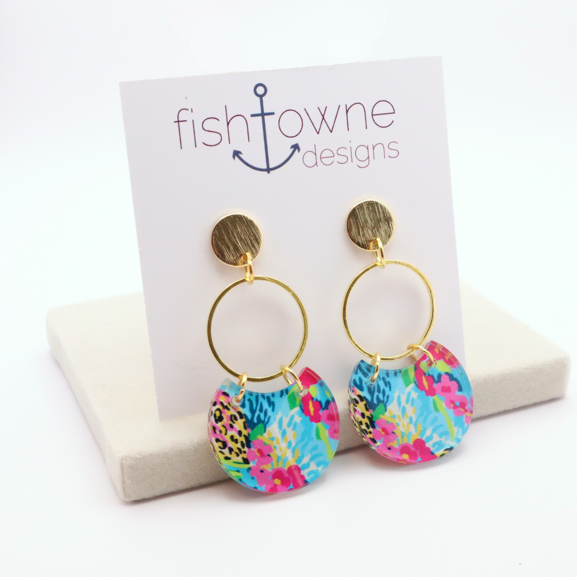 Colorful acrylic dangle earrings with bright floral and abstract print on gold hoop with 18k gold plated stud posts on display card