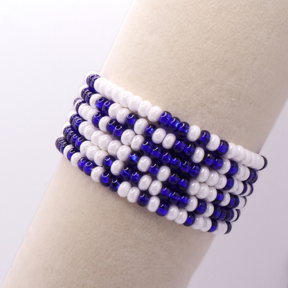 Set of six blue and white seed bead stretch bracelets featuring random blue and white seed beads on a white background