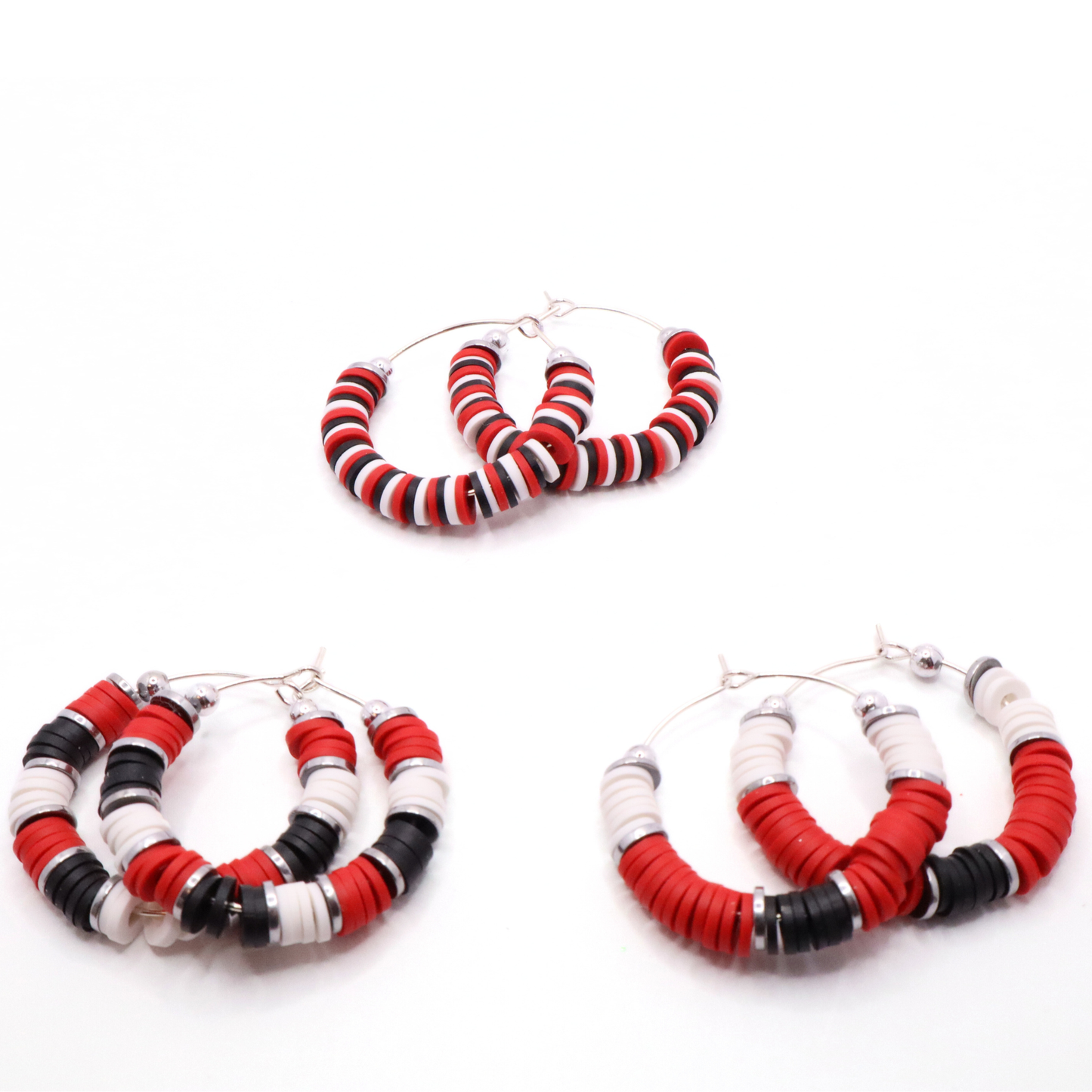 Set of three red, white, and black heishi bead hoop earring styles arranged on a white background, showcasing size and pattern variations