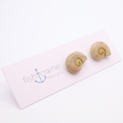Cream and blush marbled shell stud earrings with gold swirl detail on white display card