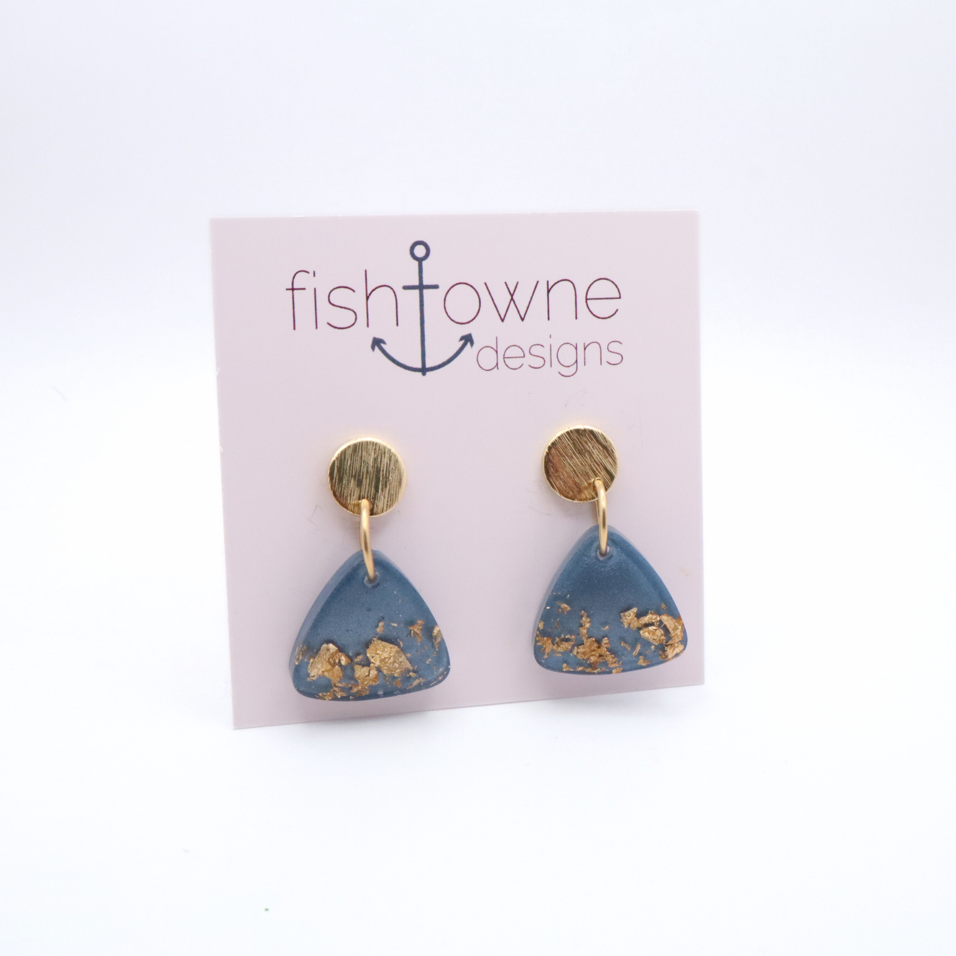 Blue triangle earrings with gold accents on a Fish Towne Designs card.