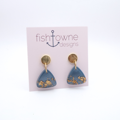 Blue triangle earrings with gold accents on a Fish Towne Designs card.