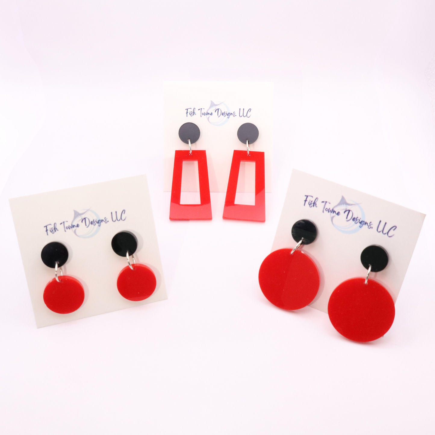 Red and black earrings on display cards with 'Fish Towne Designs, LLC' branding.
