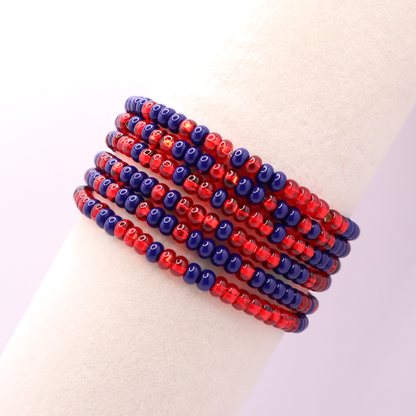 Set of six navy blue and red seed bead stretch bracelets featuring random navy blue and red seed beads on a white background