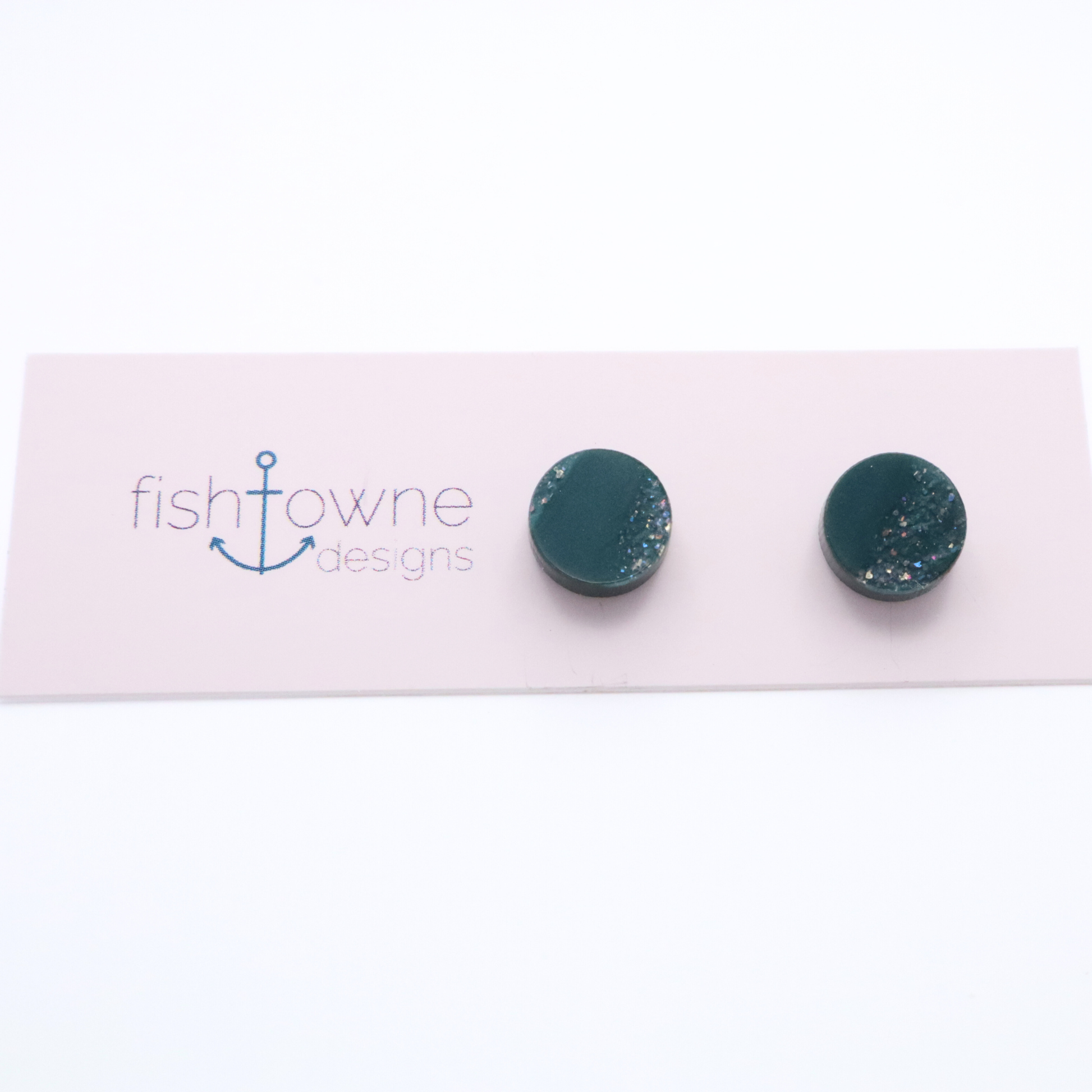Teal stud earrings on a Fishowne Designs card against a white background