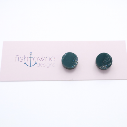 Teal stud earrings on a Fishowne Designs card against a white background