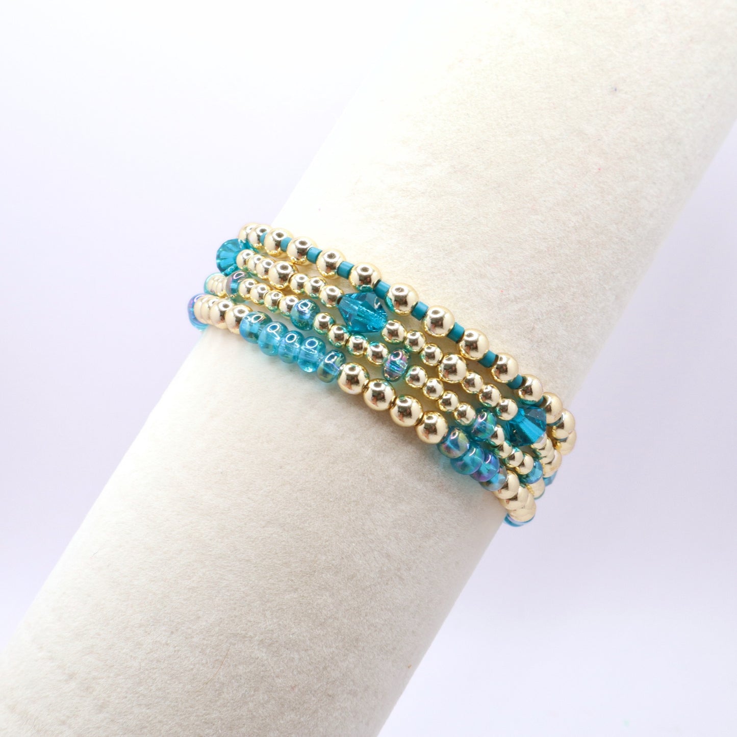 Handmade blue stretch bracelet set featuring gold-tone hematite beads.