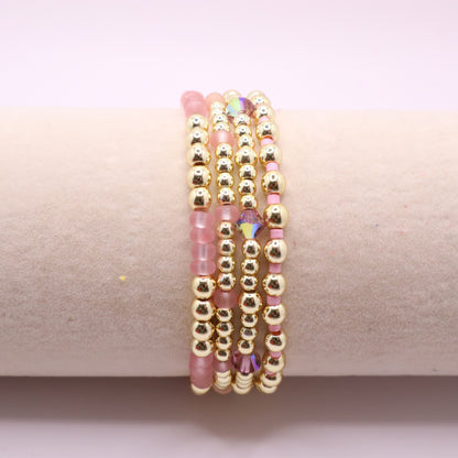 Delicate blush pink beaded bracelet stack with sparkling crystal details.