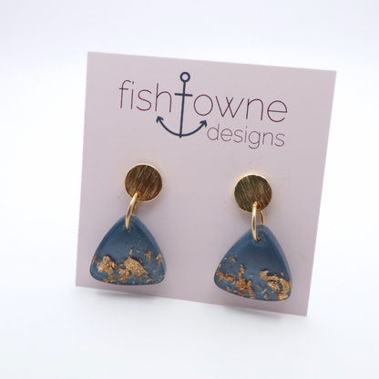 Blue and gold earrings on a Fish Towne Designs card against a white background