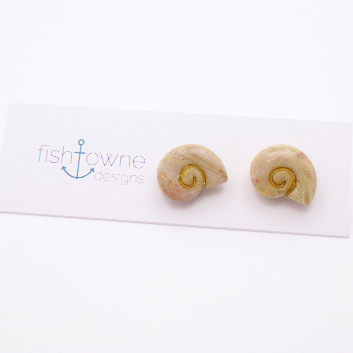 Handmade resin shell stud earrings in soft neutral tones with subtle gold shimmer accents