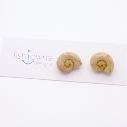 Handmade resin shell stud earrings in soft neutral tones with subtle gold shimmer accents