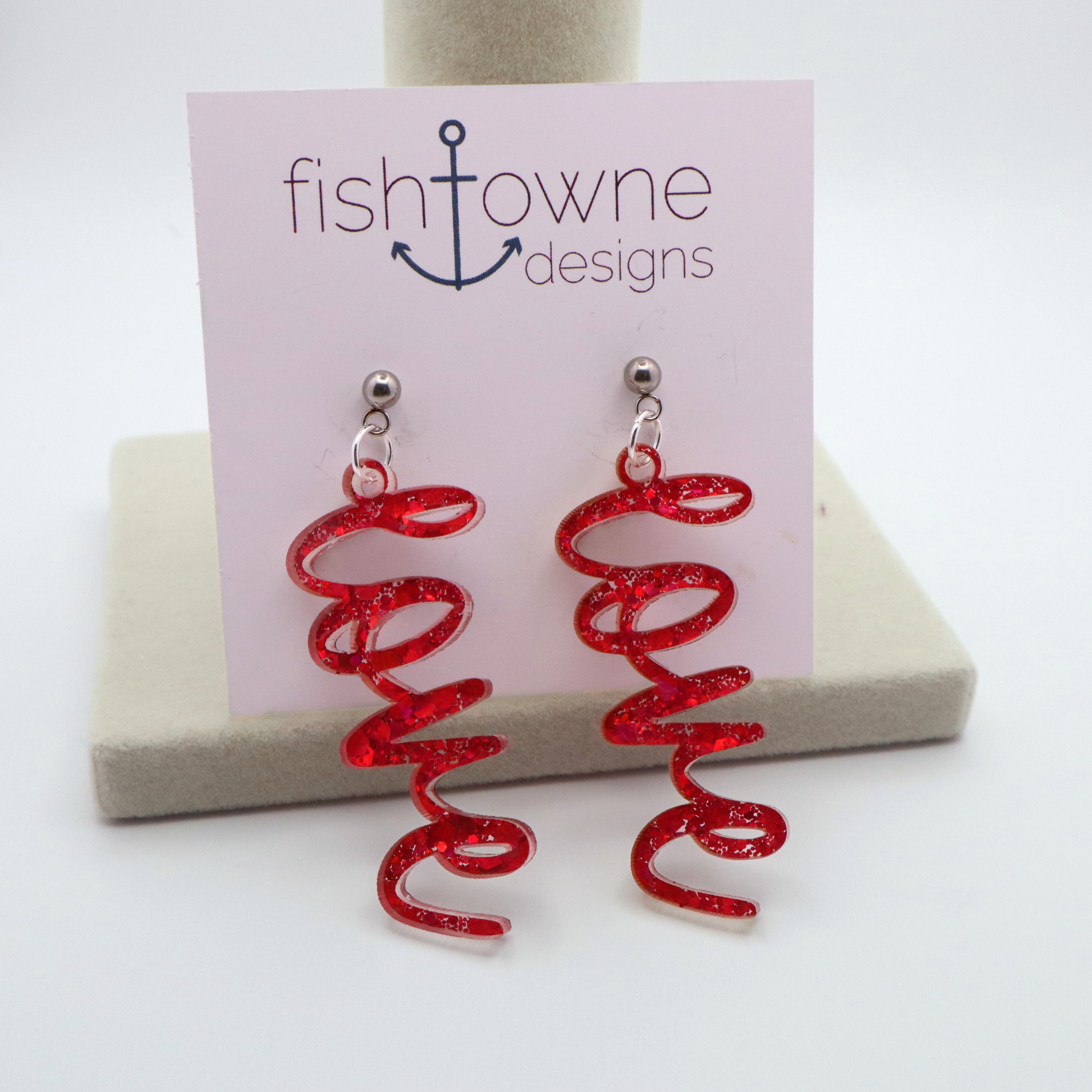 Pink glitter 'love' earrings on a Fish Towne Designs display card