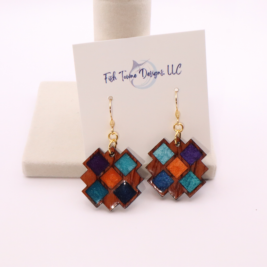 Colorful geometric earrings on a Fish Towne Designs card against a white background