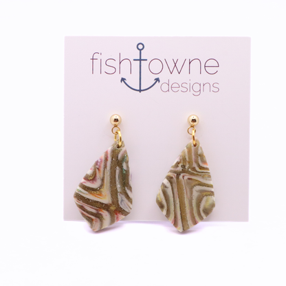 Marbled polymer clay geometric earrings in tan, cream, and soft pink with gold accents and stainless steel studs on white background