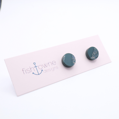 Teal stud earrings on a Fish Towne Designs card against a white background