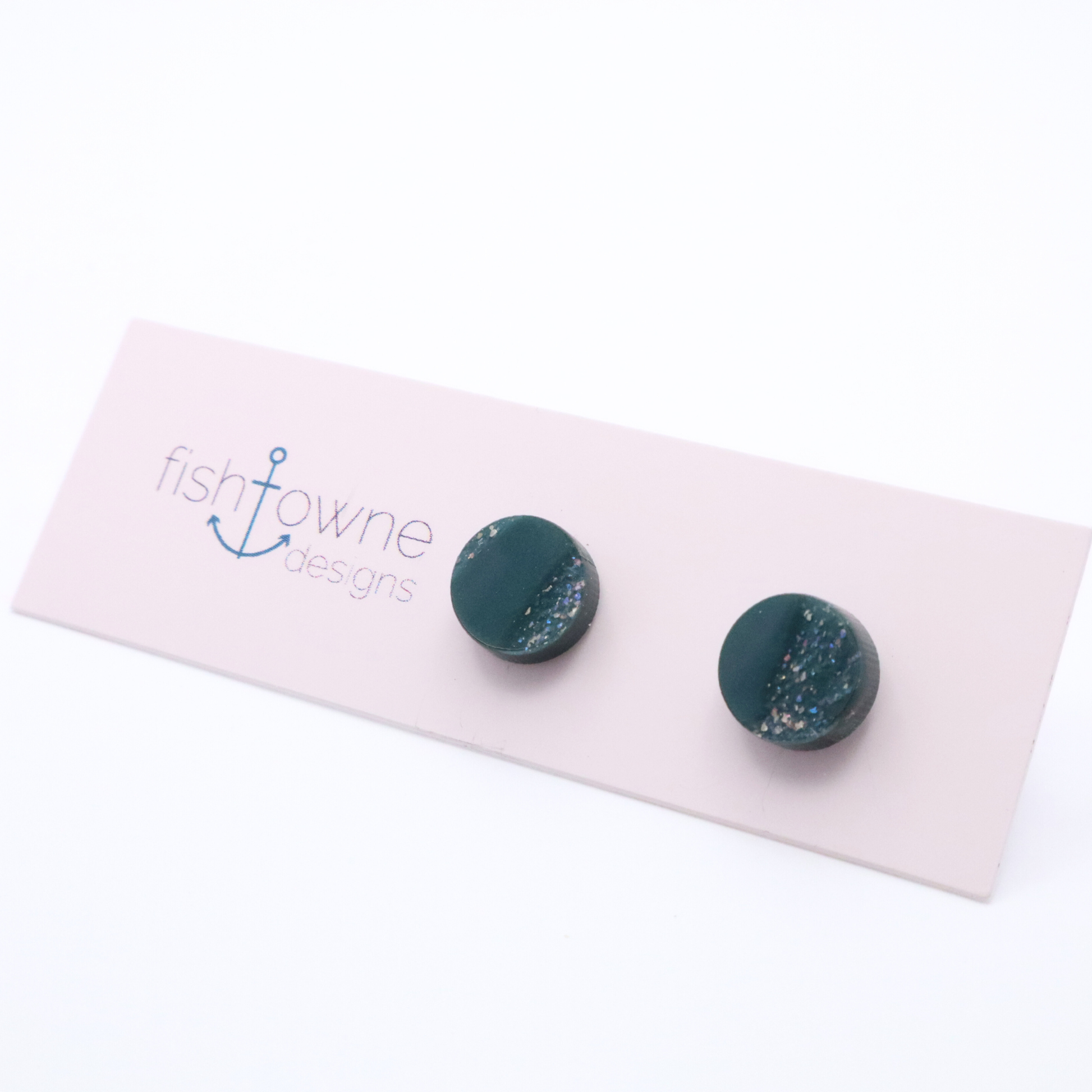 Teal earrings on a Fish Towne Designs card against a white background