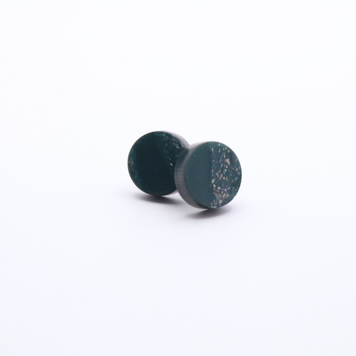Pair of teal green speckled earrings on a white background