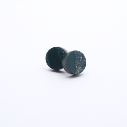Pair of teal green speckled earrings on a white background