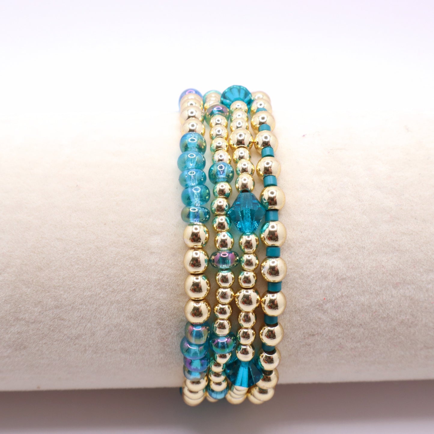Gold hematite bracelets with soft blue seed beads and crystal details.