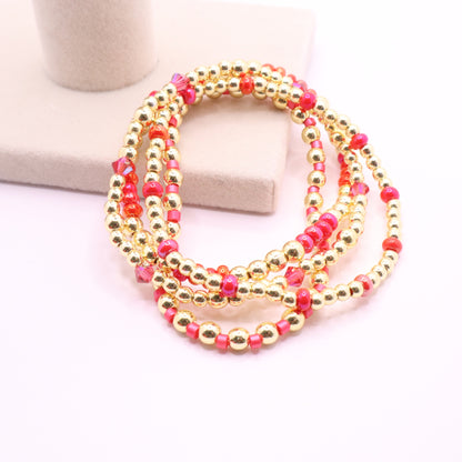 Bright pink bracelet set with sparkling crystal accents and gold-tone hematite beads.