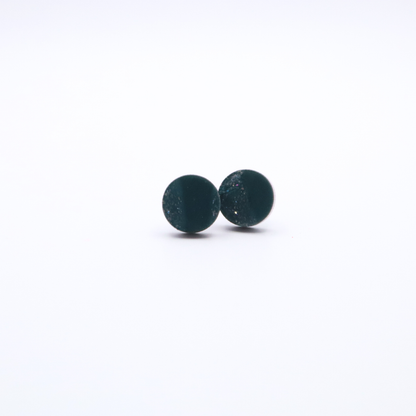 Pair of teal green round stud earrings on a white background