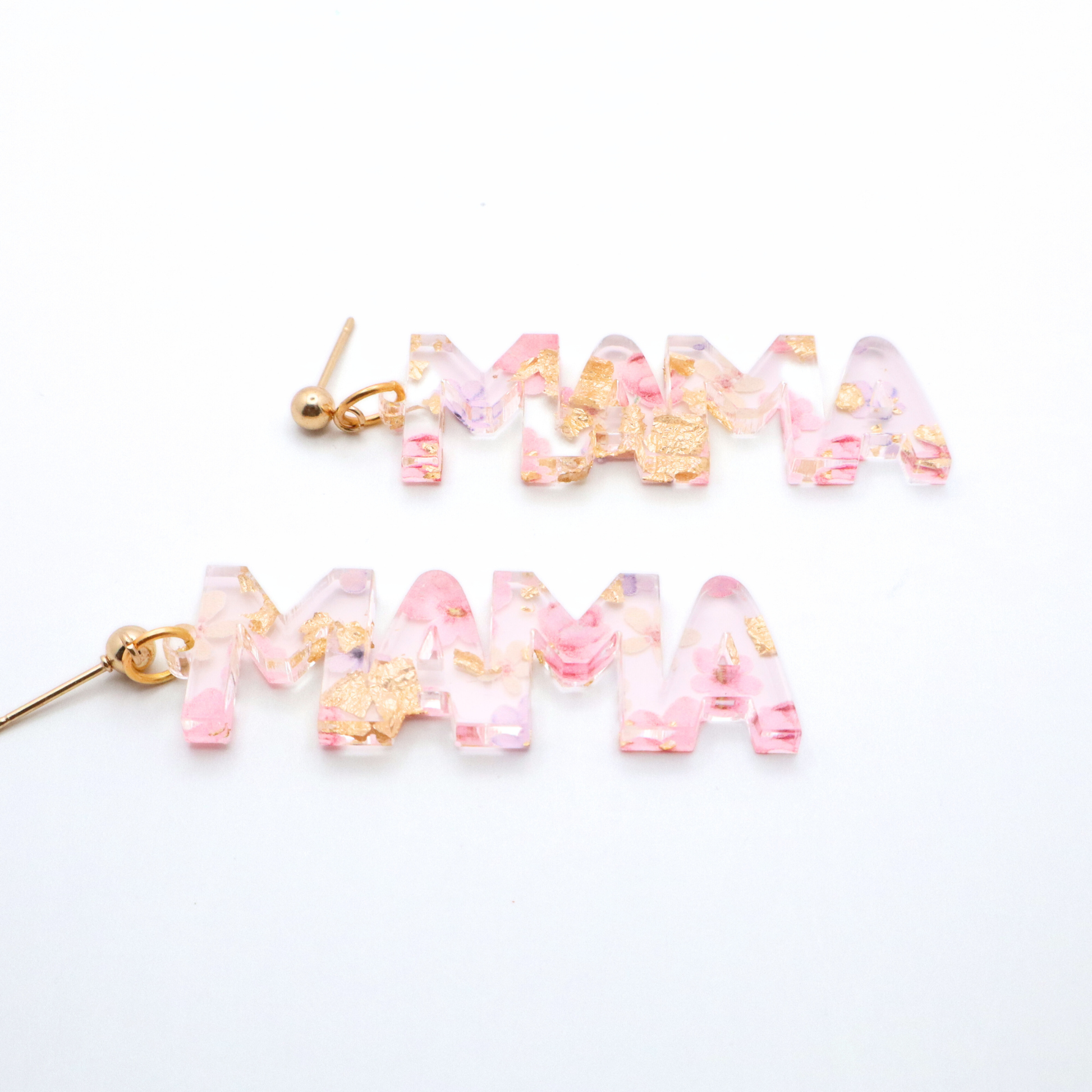 pink and gold floral 'MAMA' earrings on a white background