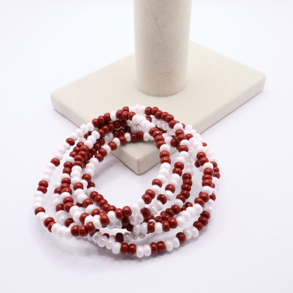 Set of six crimson and white seed bead stretch bracelets featuring random crimson and white seed beads on a white background