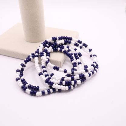 Set of six navy blue and white seed bead stretch bracelets featuring random navy blue and white seed beads on a white background