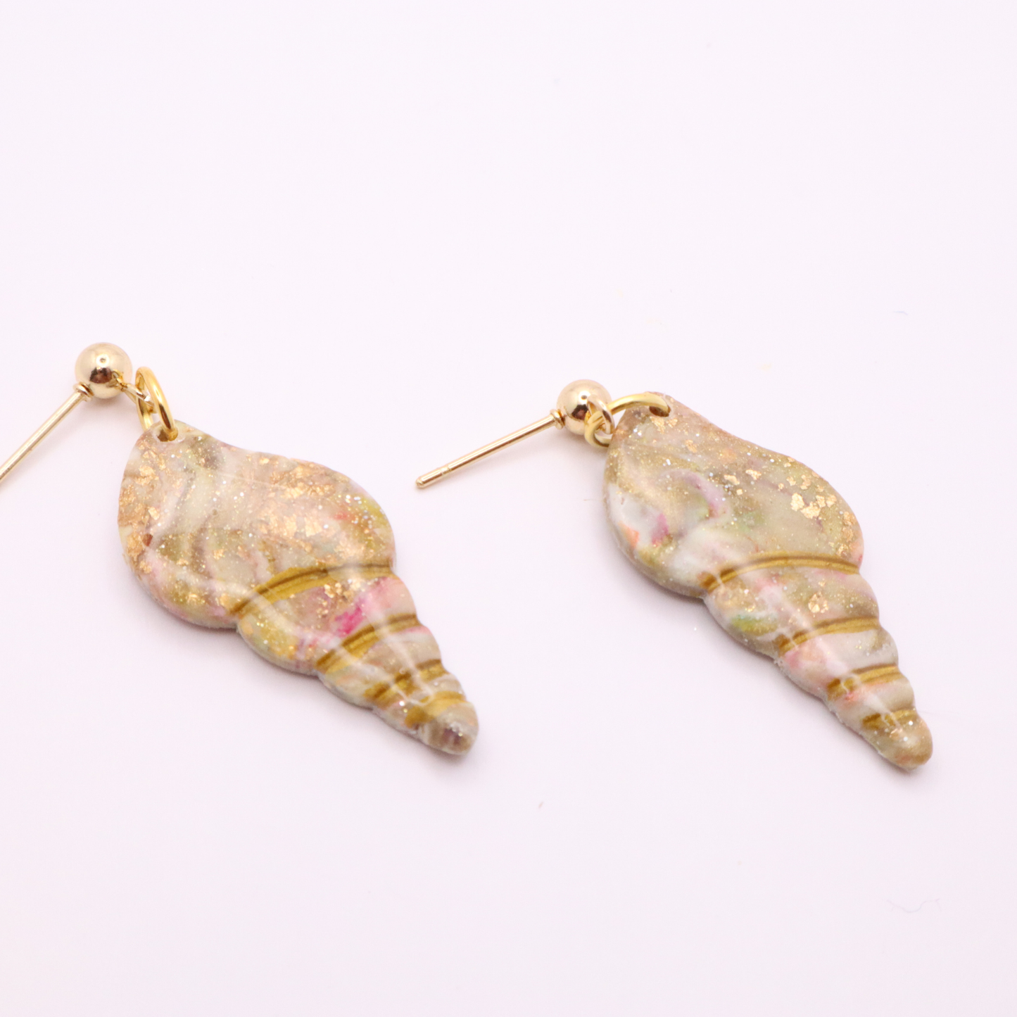Ocean-inspired seashell dangle earrings with marbled pastel tones and gold leaf details