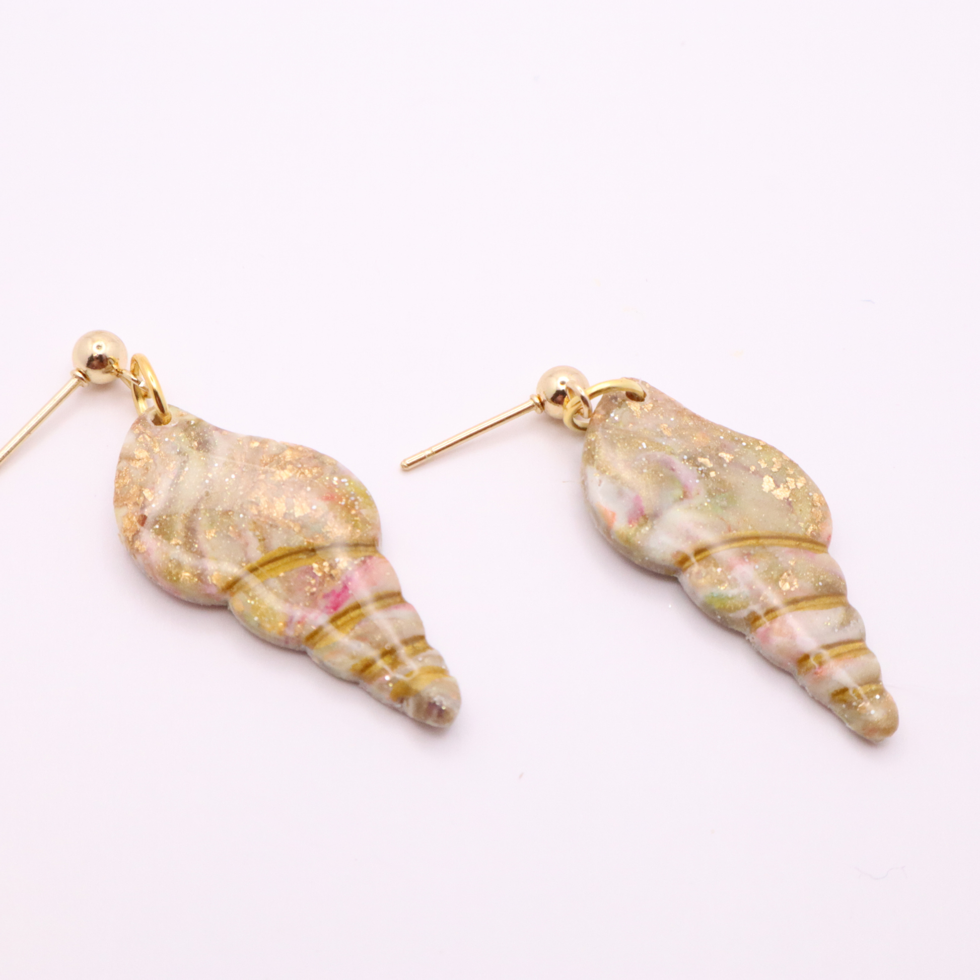Ocean-inspired seashell dangle earrings with marbled pastel tones and gold leaf details