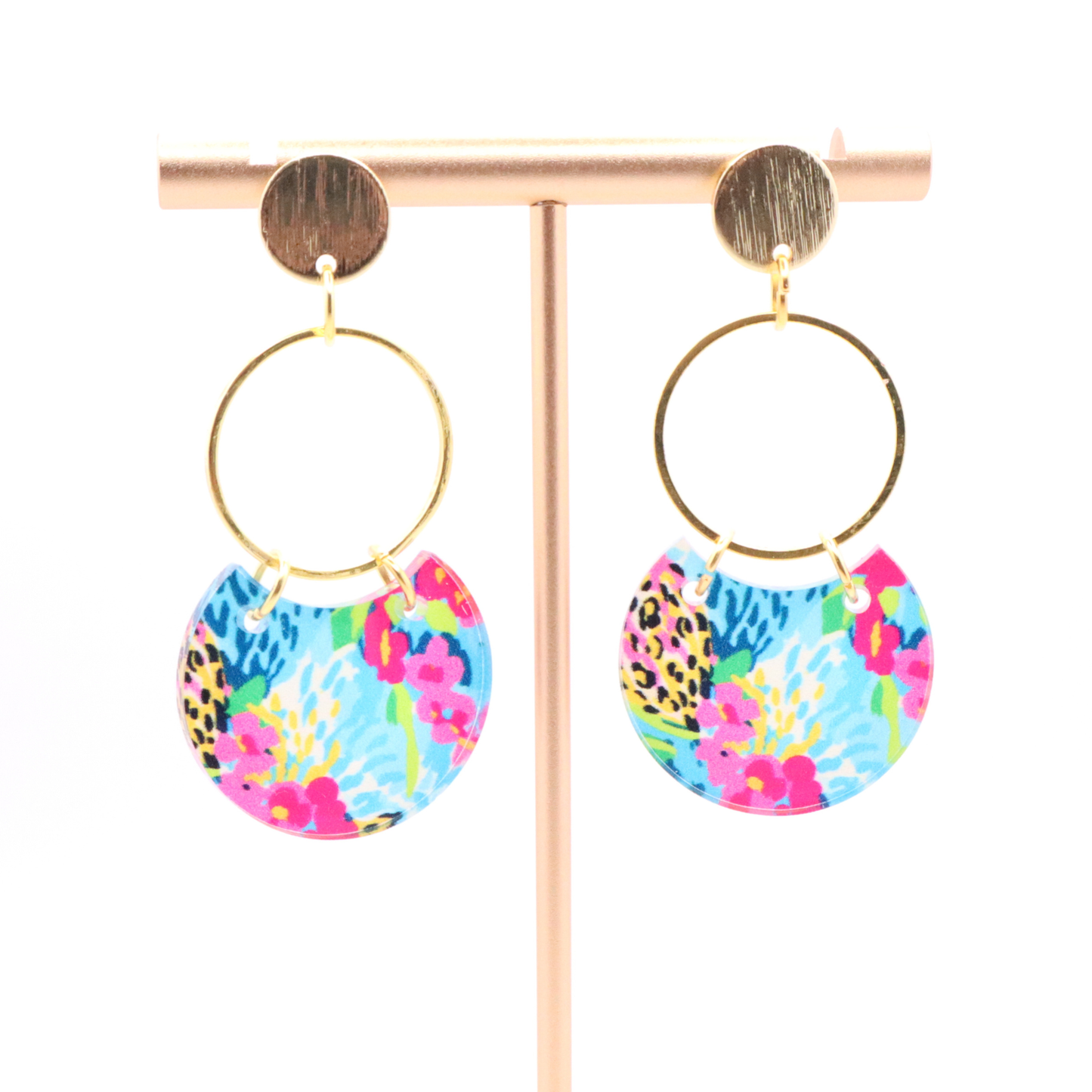 Lightweight acrylic dangle earrings featuring bold blue, pink, and yellow floral print with gold hoop and 18k gold plated stud posts