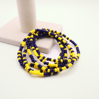Set of six navy blue and yellow seed bead stretch bracelets featuring random navy blue and yellow seed beads on a white background