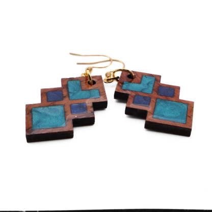 Wooden square earrings with blue and brown design on a white background