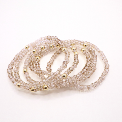 set of six neutral gold tone seed bead bracelets featuring high quality neutral seed beads and golden hematite accent beads.  The stack is displayed on a white background.