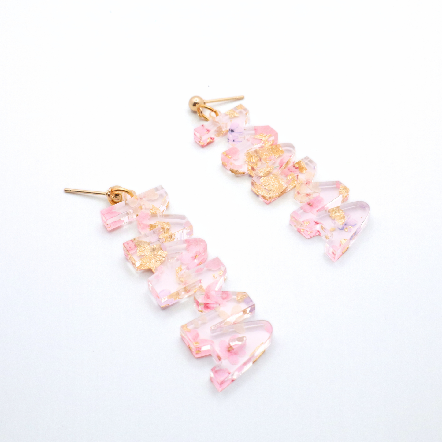 Pair of pink floral mama earrings on a white background