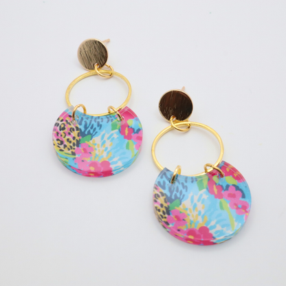 Handmade acrylic earrings with tropical inspired colorful pattern attached to gold hoop and 18k gold plated textured stud posts